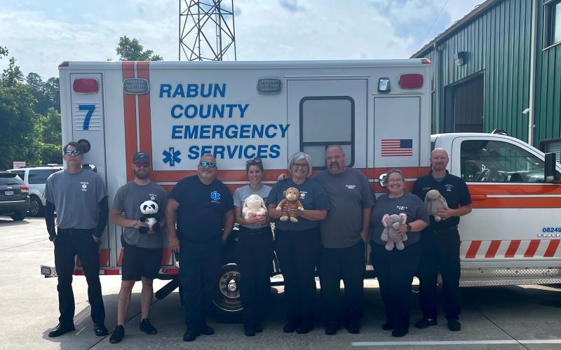 Submitted photo. Rabun County EMS receives a donation of stuffed animals from The Ryan Batchelder Foundation “Little Hugs.” Holding some of the donations are Paramedic Gary Jones; Paramedic Jackson Fischer; Paramedic David Lyle; AEMT Annie Lewis; Lieutenant Tammy Jones; EMT-I Josh Hickox; Paramedic Elisha Higgins; and Lieutenant David Cavender.