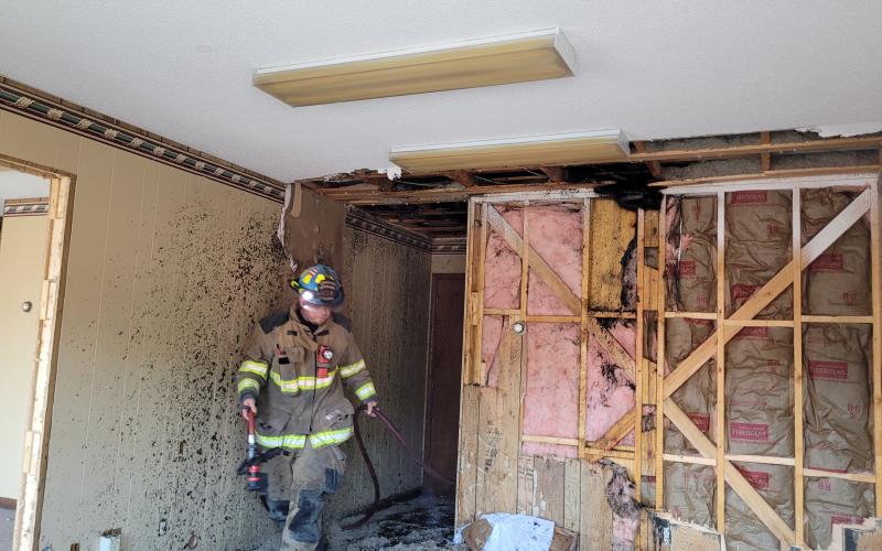 Megan Broome/The Clayton Tribune. Firefighters search the Ed West Realty building on Savannah Street after being dispatched to a rekindling following a call for a possible structure fire at the same location almost 12 hours earlier, where a small fire possibly caused by lightning was found in the attic.