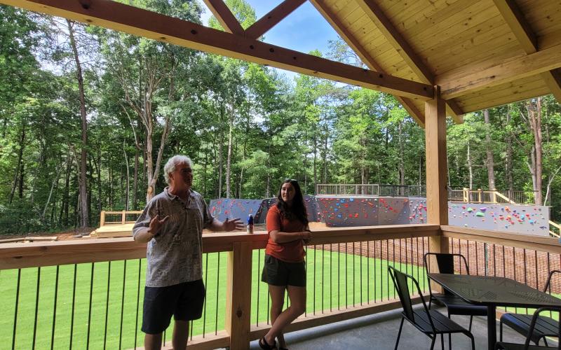 Megan Broome/The Clayton Tribune. Bill Turk, owner of Tallulah Adventures, and Spencer Turk, operations and events manager for Tallulah Adventures, speak to Rotarians about the Adventure Zone and the different activities and facilities available at its club meeting that was held there July 21.
