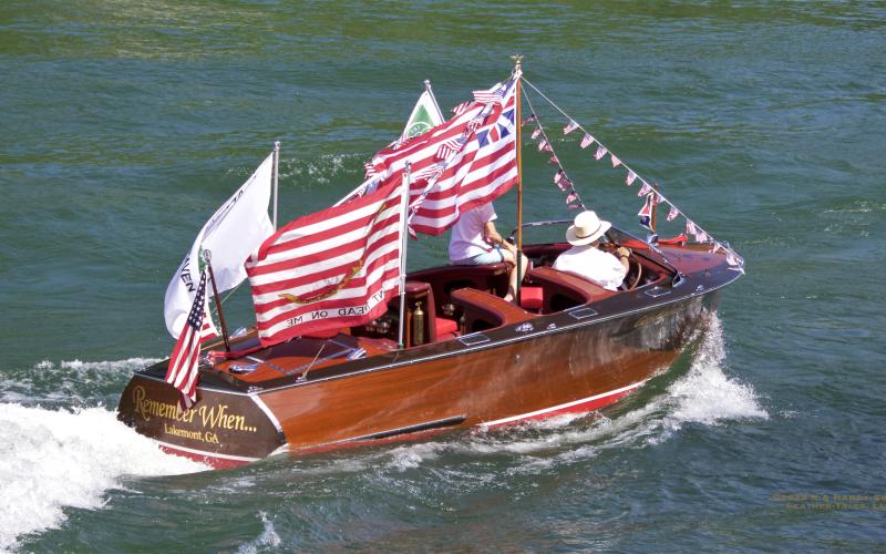 Photo courtesy of KA Hamdy-Swink. The “Remember When” 1940 GarWood Streamliner Triple cockpit 23’ owned by Bob and Belle Voyles makes an appearance in the Wooden Boat Parade.