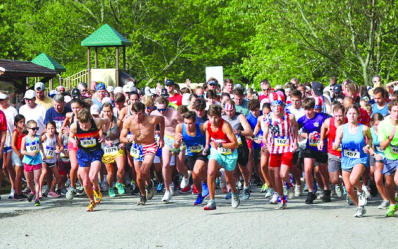 Photography courtesy Melissa Elzey. The combined 1,300 runners and walkers begin the two-mile fun run from Moccasin Creek in Clarkesville.