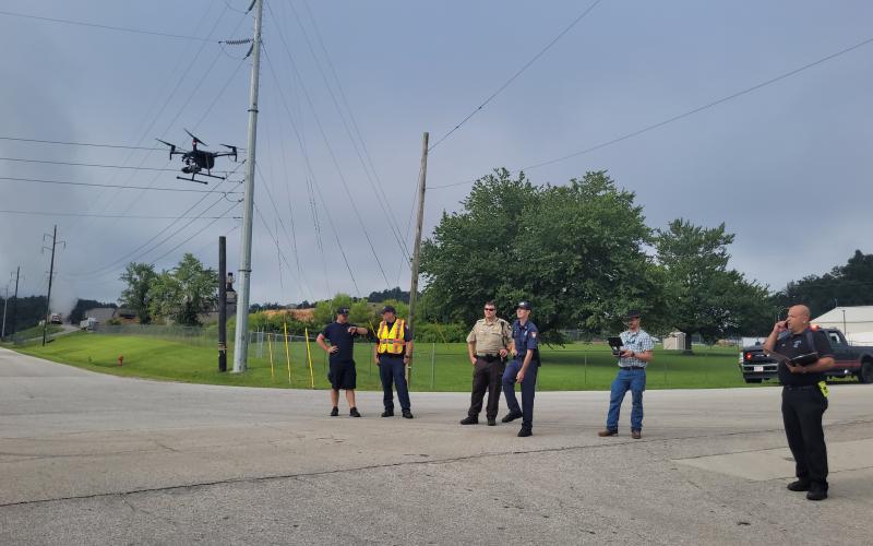 Megan Broome/The Clayton Tribune. EMA personnel work the scene on Kellys Creek with a UAS Drone.