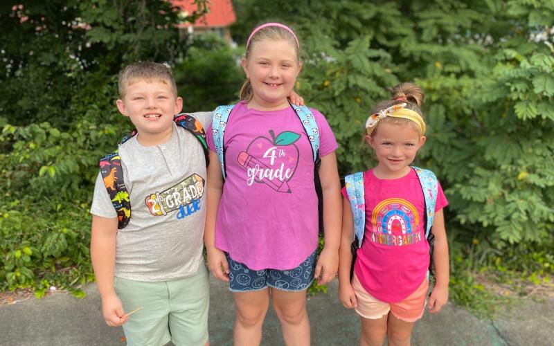 Submitted photo. Second grader Samuel Hopper, left, fourth grader Kaia Hopper and kindergartener Katie Hopper show off their decorative grade shirts before heading to Rabun County Schools for their first day.