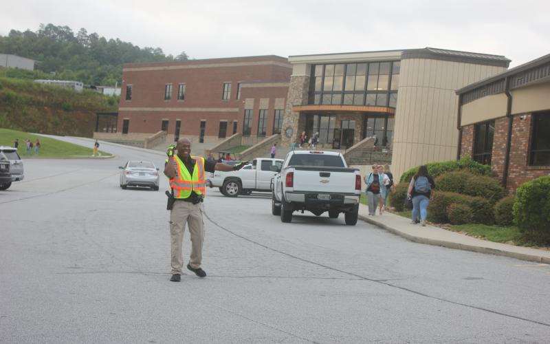 Megan Broome/The Clayton Tribune. Rabun County School High School Resource Deputy (SRD) Sgt. Lindsey Owens directs traffic and keeps students safe for the first day of school on August 5.