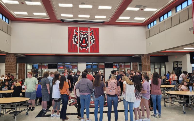 Megan Broome/The Clayton Tribune. Students at Rabun County Schools gather in a circle to pray and pump each other up in the cafeteria before the bell rings to begin classes for the day.