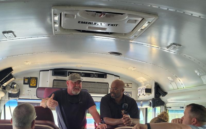 Megan Broome/The Clayton Tribune. Lt. Mark Gerrells and Sgt. Lindsey Owens, School Resource Deputy at the high school, talk to bus drivers at the Board of Education Tuesday as part of their annual safety training to prepare for kids as they go back to the classroom Friday. They talked to bus drivers about the importance of situational awareness and being aware of surroundings. He referred to the buses as “mobile classrooms” and talked about what to do in the instance of an active shooter situation.