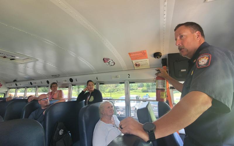 Megan Broome/The Clayton Tribune. Assistant Fire Chief Justin Upchurch talks to bus drivers about fire extinguisher safety and what to do in emergent situations. This was part of training for bus drivers at the Board of Education Tuesday for their annual safety training to prepare for kids as they go back to the classroom Friday.
