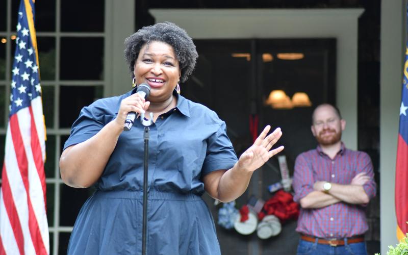 Enoch Autry/The Clayton Tribune. Democratic nominee Stacey Abrams addresses the crowd at the Parker Ranch on July 29. Standing behind Abrams is Charlie Bailey, who seeks the elected position of lieutenant governor.