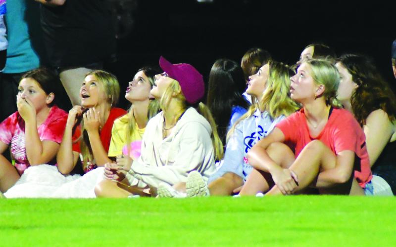 Enoch Autry/The Clayton Tribune. Seated in the back of the end zone, Rabun County students watch as field goal attempts during the “Midnight Madness” fly high over their heads. The Wildcats took the field for practice Monday at 12 a.m.