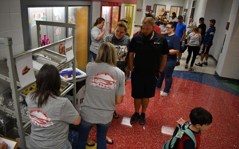 Enoch Autry/ The Clayton Tribune. Wearing their ‘City on the Hill’ T-shirts, Rabun County Elementary School staff provide breakfast meals to students on the first day of school.