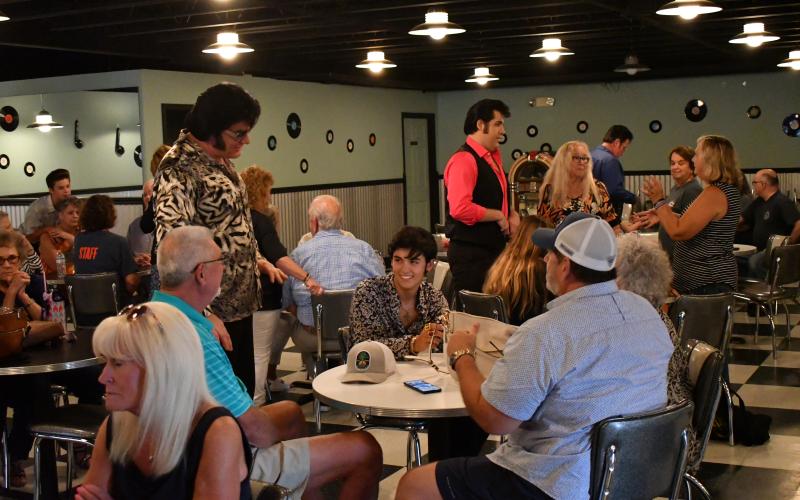 Enoch Autry/The Clayton Tribune. Here World Champion David Lee and 2021 Big E winner Austin Irby talk with guests at the event.
