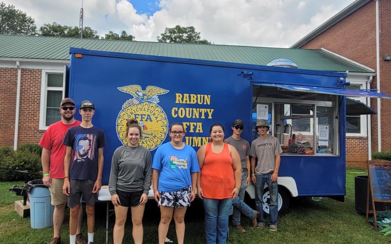Megan Broome/The Clayton Tribune. Rabun County FFA served up good food at the 25th Dillard Bluegrass and Barbeque Festival August 5 and 6. Pictured are Rabun County FFA members James Hale, instructor; Noah Thurmond; Loren Mazarky; Ashlyn Dixon; Jalynn Pendry; Jonathan Aughtman; and Ethan Mazarky. Not pictured are Peyton Hicks; Eli Owens; and Melanie Beck.