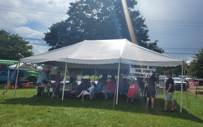 Megan Broome/The Clayton Tribune. Kyle Bryner hosted a “Cooking with the Pros” cooking class for a crowd each day during the 25th Dillard Bluegrass and Barbeque Festival August 5 and 6.