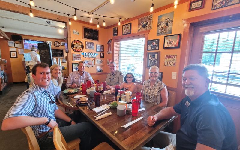 Megan Broome/The Clayton Tribune. Gov. Brian Kemp and Georgia First Lady Marty Kemp have a chicken sandwich with fries for lunch with local officials at The Rusty Bike Café Aug. 4 when the governor made a visit to Rabun County to meet-and-greet members of the community. Pictured are Hunter Spear, Northeast Georgia field director for Kemp for Governor, left; Georgia First Lady Marty Kemp; Georgia Gov. Brian Kemp; Sheriff Chad Nichols; Joslan Nichols; Cathy Cannon; and Clayton Mayor Kurt Cannon.