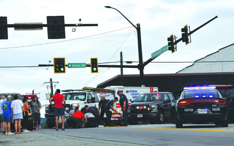 Enoch Autry/The Clayton Tribune. Rabun County emergency personnel assist a pedestrian who was struck by a vehicle in downtown Clayton.