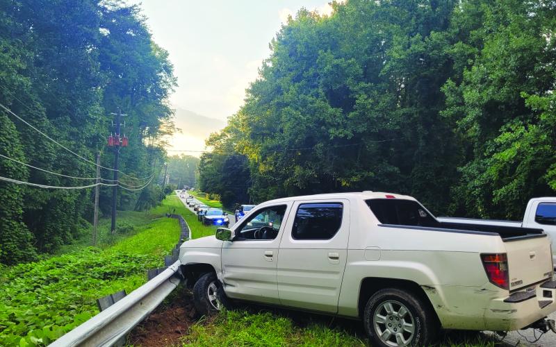Megan Broome/The Clayton Tribune. Rabun County emergency personnel work the scene of a single vehicle crash on Highway 76 east just before the intersection of Old Chechero Road in Clayton on Aug. 15. A Rosman, N.C., man experienced a medical emergency prior to crashing into a guardrail.
