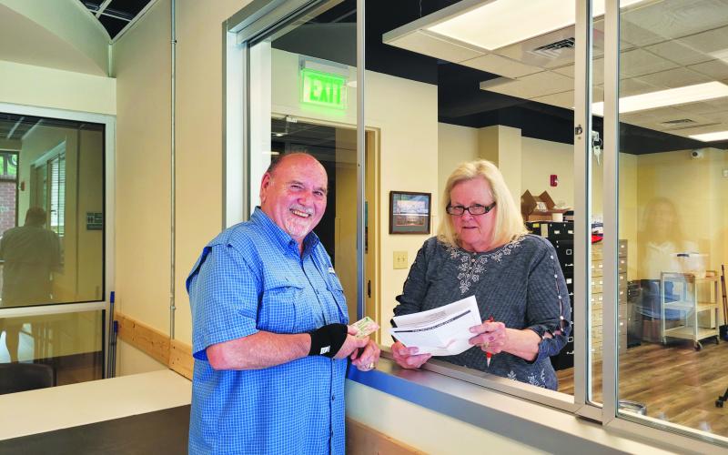 Megan Broome/The Clayton Tribune. Chuck Coulson, left, updates his voter registration information with Sandra Wood, elections and registrations clerk, at the Rabun County Board of Elections and Registrar’s Office recently.