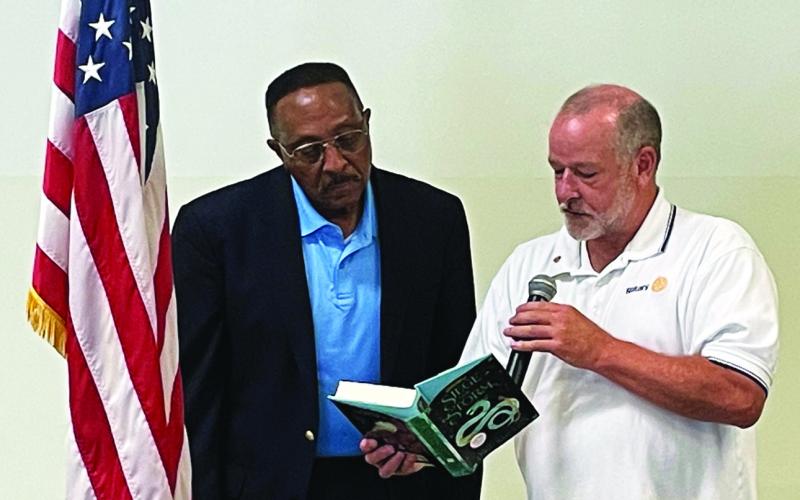 Photo courtesy of Jim Antosiak. Rotary Club of Clayton President Leif Ericson, right, presents a book to NASA Astronaut Winston Scott at the Rotary Club of Clayton meeting after Scott spoke Aug. 18. The book was autographed and donated to a local school library in Rabun County.