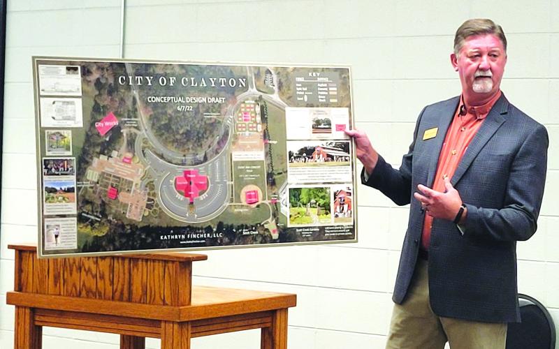 Megan Broome/The Clayton Tribune. Clayton Mayor Kurt Cannon unveils plans for the proposed new complex on the city’s 18-acre property at a city council meeting in August. Plans are to have a new city hall, theater, gardens, and concert area.