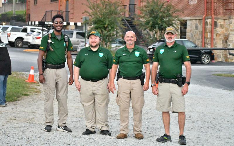 Megan Broome/The Clayton Tribune. Jonathan Cooper, Kenny Findley, Craig Neff and Tony Waite with Mountain Lakes Security work to keep the community safe during the concert.