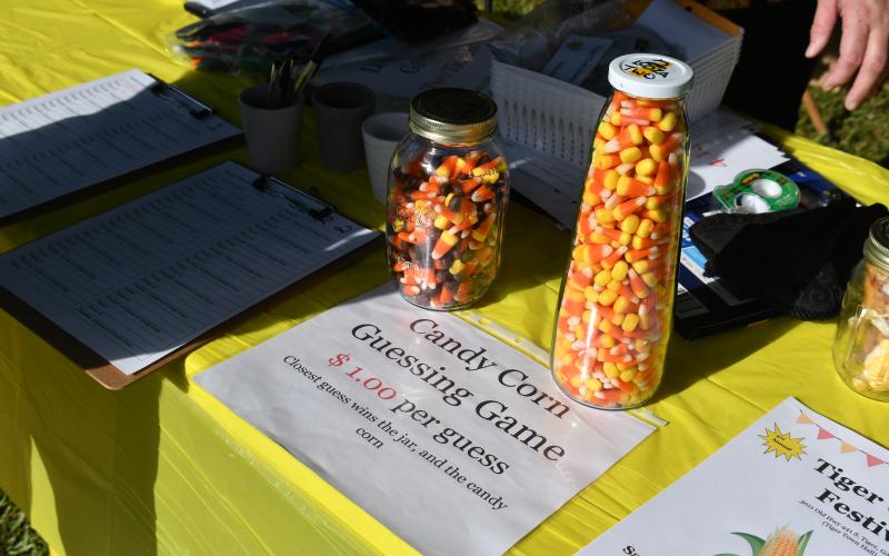 Megan Broome/The Clayton Tribune. Attendees at the Tiger Corn Festival guessed how many corn kernels were in the jar and the winner received the jar.