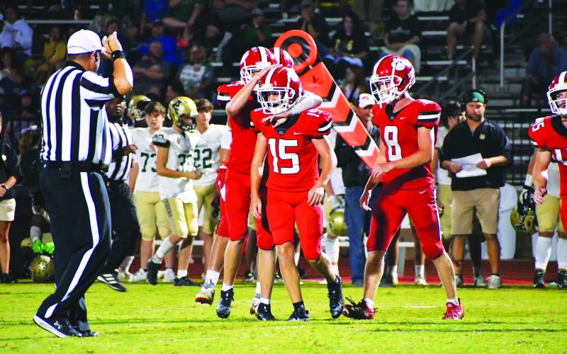 Luke Morey/The Clayton Tribune. Freshman Reid Giles (middle)receives congratulations from junior Jarret Giles (left) and senior Cory Keller after Reid forced a fumble in the fourth quarter.
