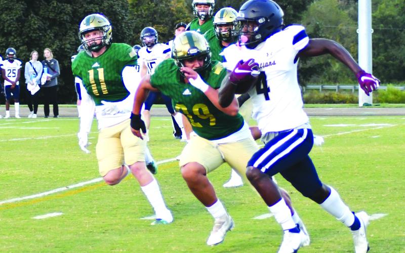 Enoch Autry/The Clayton Tribune. University Christian senior running back Orel Gray cuts sprints by Rabun Gap-Nacoochee’s Joaquin Acuna (29) and Noah Classen (11) in the Christians’ 49-13 win as the school from Florida came to North Georgia Sept. 23. Gray had 284 rushing and receiving combined yards.