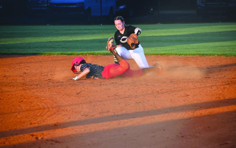 Luke Morey/The Clayton Tribune. Senior Mary Lovell slides into second base against Commerce.