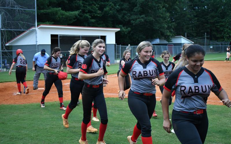 The Lady Cats celebrate a two-run home run from senior Mary Lovell (left) against Habersham Central.