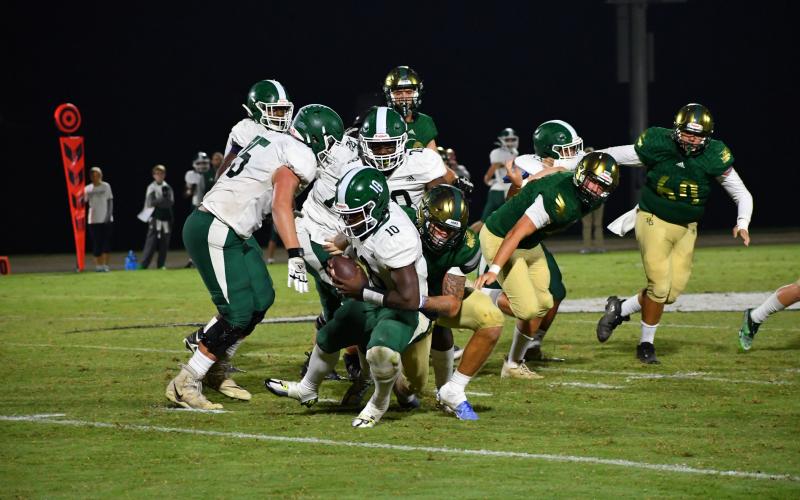 Luke Morey/The Clayton Tribune. Senior Nickolas Roy brings down senior quarterback Tray Mauney. Roy forced a fumble against Christ School. This was Roy’s first sack of the season as he averages 7.5 tackles per game.