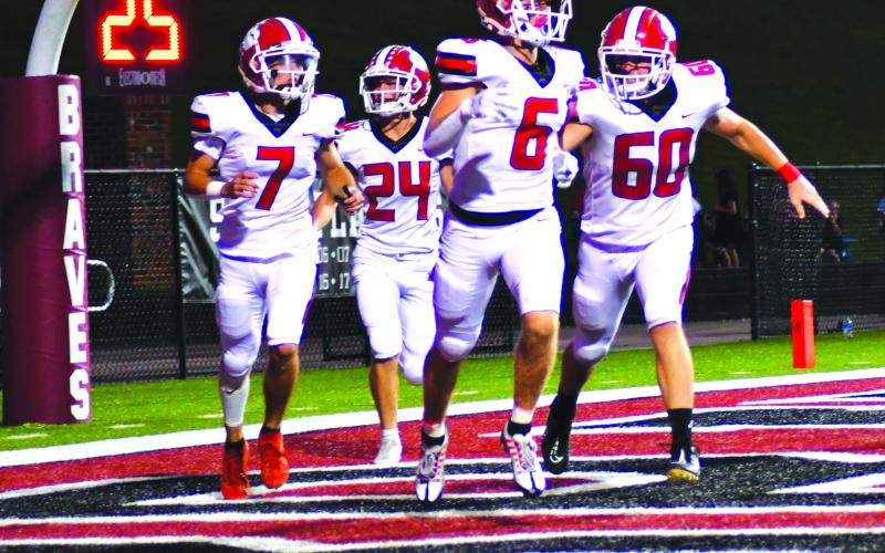 Enoch Autry/The Clayton Tribune. Rabun County’s Jaden Gibson (6) receives congrats from Braxton Brady (60), Lang Windham (7), and Riley Stewart (24) after the senior receiver scores the first of his two TDs in the win.