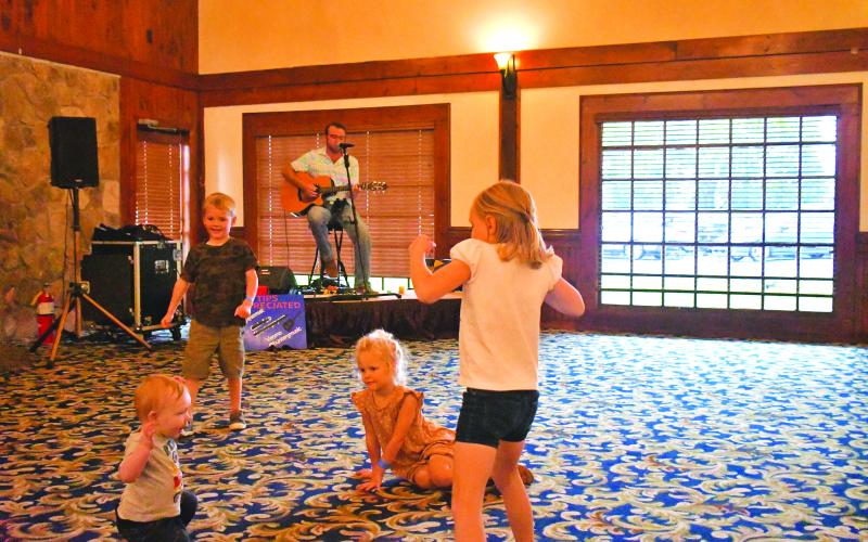 Megan Broome/The Clayton Tribune. Hayes Wills, 1, Hazelyn Whitsel, 3, Lorelai Wills, 5, and Holton Whitsel, 5, have a great time dancing to music performed by Hunter Grayson at The Dillard House Sept. 4.