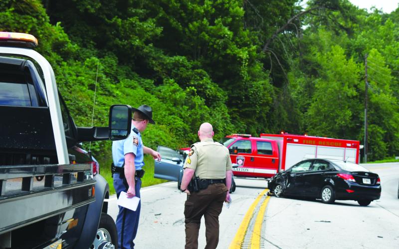 Megan Broome/The Clayton Tribune. Georgia State Patrol Trooper Brady Galloway and Rabun County Sheriff’s Office Sgt. Cody Sanders analyze the scene of a four-vehicle crash on Georgia 15 at File Street near George Eller Curve in Mountain City September 5.