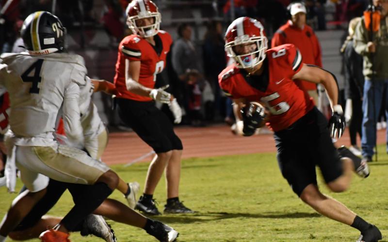Luke Morey/The Clayton Tribune. Rabun County senior Jaden Gibson runs past defensive back Ayden Duncanson for his third touchdown of the night. Gibson has 13 touchdowns on the year, only six away from the most career recieving touchdowns in the Georgia state history.