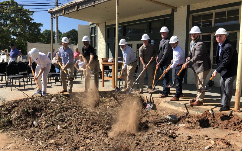 Tony Penrose/The Clayton Tribune. Mat Barnwell (left) Tyler Caswell, Jamie Langham, Micah McCracken, Stan Gunter, Clayton Mayor Kurt Cannon, Peter Evers, Sen. Bo Hatchett, and Rabun County Director of Development Rick Story break ground on the Bridge Creek Inn during a ceremony Sept. 21. It is expected to open Labor Day 2023.