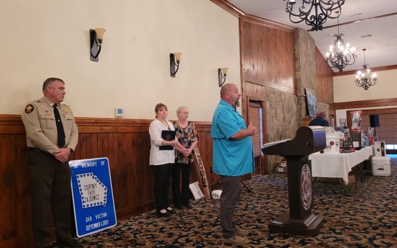 Megan Broome/The Clayton Tribune. Megan Broome/The Clayton Tribune. David Cross, father of Rabun County Detention Center Officer Cpl. Courtney Faith Zajdowicz, speaks to a crowd of law enforcement officers at the 31st annual Hands Across the Border event at The Dillard House August 30.