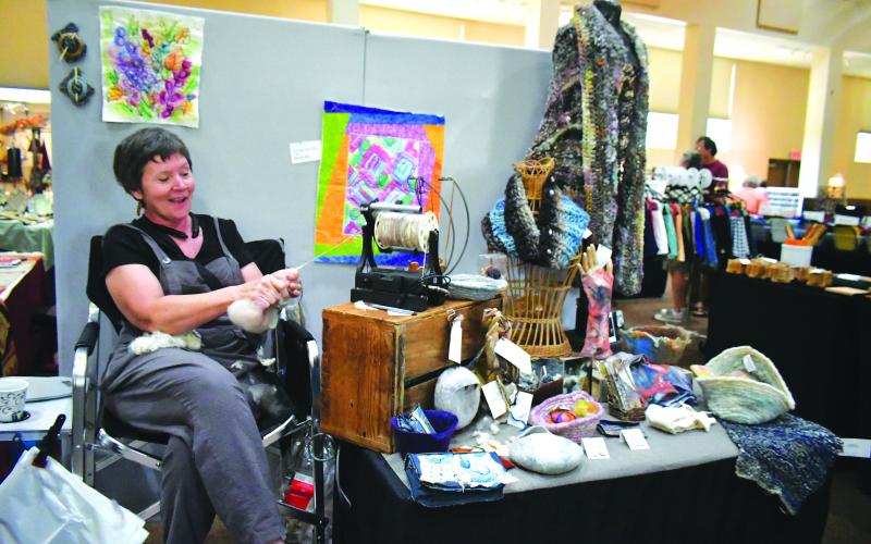 Megan Broome/The Clayton Tribune. Artist Brenda Hutchings demonstrates her craft at the Painted Fern Art Festival presented by the North Georgia Arts Guild this past weekend. Hutchings took home the win for the “Producer’s Award for Best Booth.”