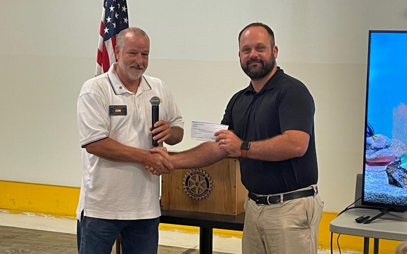 Photo courtesy of Jim Antosiak. Rotary Club of Clayton President Leif Ericson hands a $2,429 donation check to Dr. Matthew Leff at the Rotary Club of Clayton meeting Aug. 18.