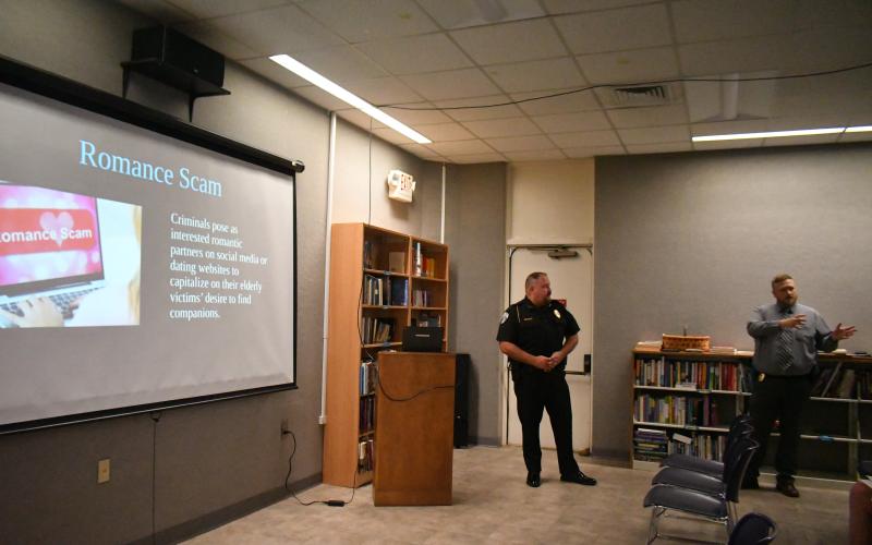 Megan Broome/The Clayton Tribune. Clayton Police Department Chief of Police Andy Strait and Investigator Matt Thomas educate the public on how to prevent becoming victim to different types of scams at the Rabun County Public Library earlier this month.