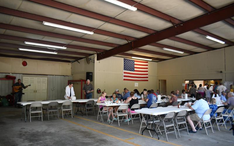 Megan Broome/The Clayton Tribune. Volunteer firefighters work at the Station 12 BBQ fundraiser last weekend.