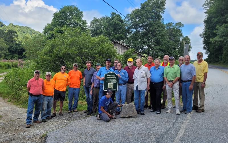 Megan Broome/The Clayton Tribune. A crowd of surveyors and community members from Georgia, North Carolina and surrounding areas gather on Hale Ridge Road at Commissioners Creek at the state line on Aug. 13 to replace and document a surveying monument, dating back to 1819, on Commissioners Rock.