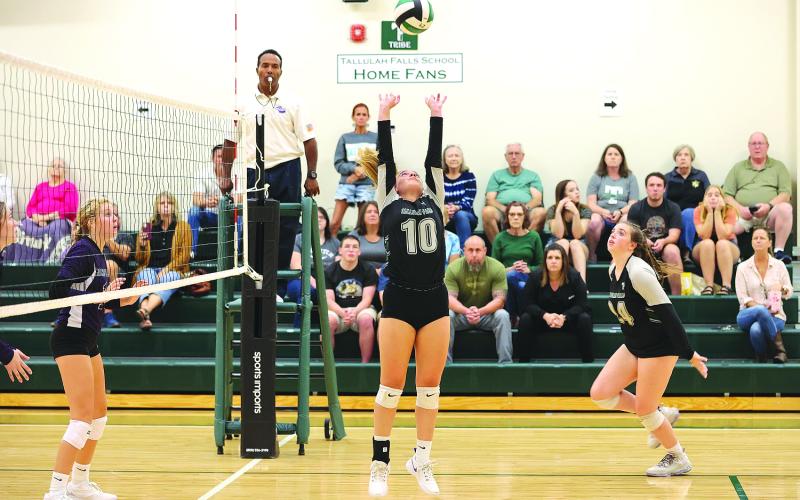 Courtesy of Austin Poffenberger. Senior Kitty Rodenas (center) sets the ball for junior Addy McCoy (right) during the Rocky Top Tournament