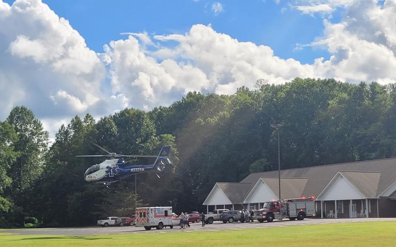 Megan Broome/The Clayton Tribune. A 71-year-old woman  is transported by AirLife after being struck by a vehicle on Aug. 25.