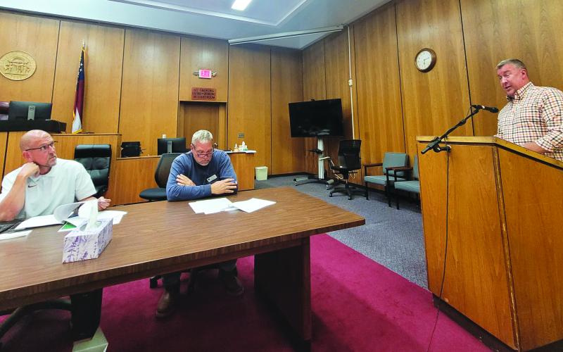 Megan Broome/The Clayton Tribune. County Attorney Allyn Stockton speaks to commissioners about amendments to the zoning ordinance for short-term rentals at the Board of Commissioners meeting Sept. 27. Commissioners Scott Crane and Tom Garrison are also pictured. Commissioners adopted the first reading of the ordinance amendment.