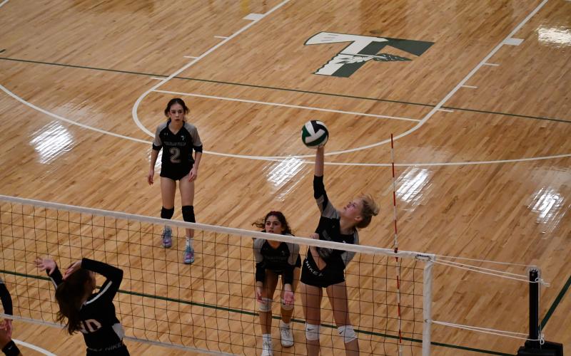 Luke Morey/The Clayton Tribune. Junior Claire Kelly goes up for a spike against Rabun County last Tuesday with seniors Chloe Kahwach (3) and Elsa Sanchez (2) looking on. Tallulah Falls won in straight sets to defeat the Lady Cats in their second to last regular season match.