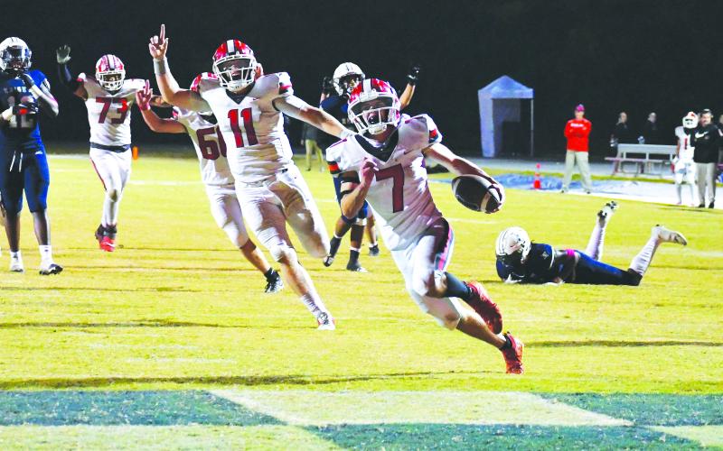 Luke Morey/The Clayton Tribune. With an excited senior quarterback Keegan Stover behind him, Rabun County senior running back Lang Windham (7) runs into the end zone for his second touchdown of the night, which ended up being the game-winning score against St. Francis. Windham finished with 19 carries on 108 yards, good for more than five yards per rush. RCHS will be on the road at region foe Elbert County Friday.