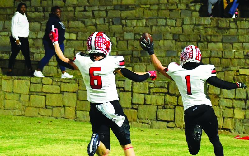 Luke Morey/The Clayton Tribune. Senior Nicholas Baloga (1) returns an interception 35 yards for a touchdown as senior Jaden Gibson celebrates.