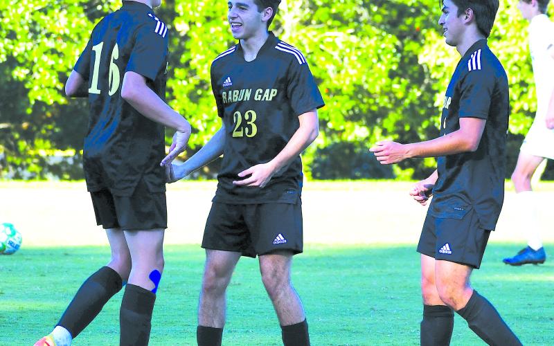 Luke Morey/The Clayton Tribune. Moteijus Samsonas (left) celebrates his goal with Marcello Gonzalez (middle) and Rafael Castillo (right) at the Eagles’ last home game on Sept. 13 against Asheville Christian Academy where the Eagles won 6-1. Samsonas is tied for second on the team in assists.