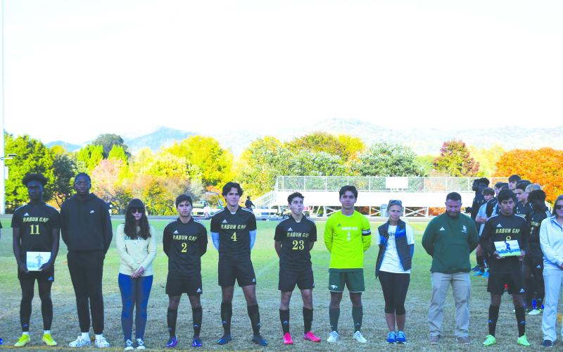 Luke Morey/The Clayton Tribune. The Rabun Gap-Nacoochee soccer seniors were honored before their last home game on Monday night. The seniors are from left, John Barta (14) with Keri Barta, Kyle Brako (11) with Tola Omatayo, Rafael Castillo (2) with Chelsea Dabrik and Guillermo Haro, Hugo Garcia (1) with Marcelo Gonzalez and Pam Weatherly, and Emilio Roman (8) with Mark Green and Alex Fagin.