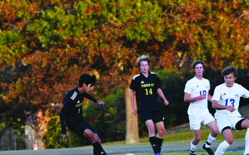 Luke Morey/The Clayton Tribune. As senior John Barta looks on, senior Emilio Roman scores the first goal against Bob Jones Academy on Monday. Roman scored his 25th and 26th goal of the season on Monday.